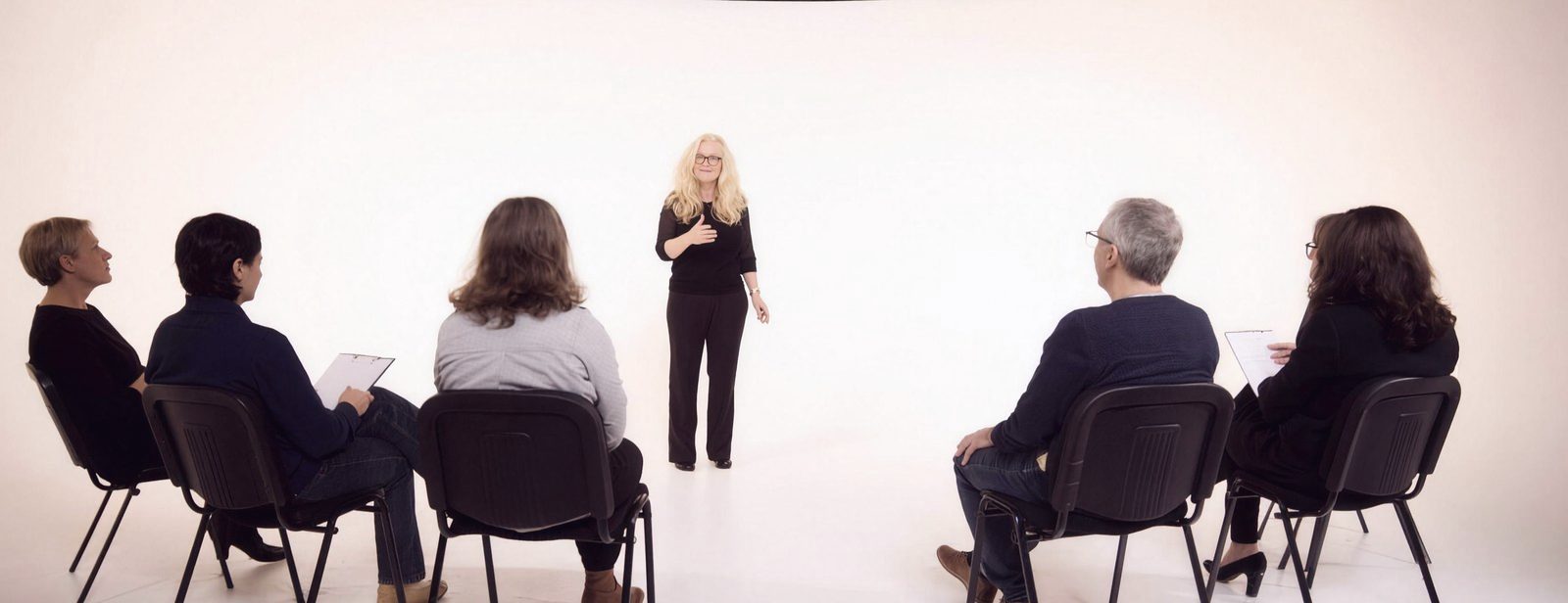 A Jawsmith session in a studio, participants seated in a semicircle while Hilary Jeffs leads from the floor