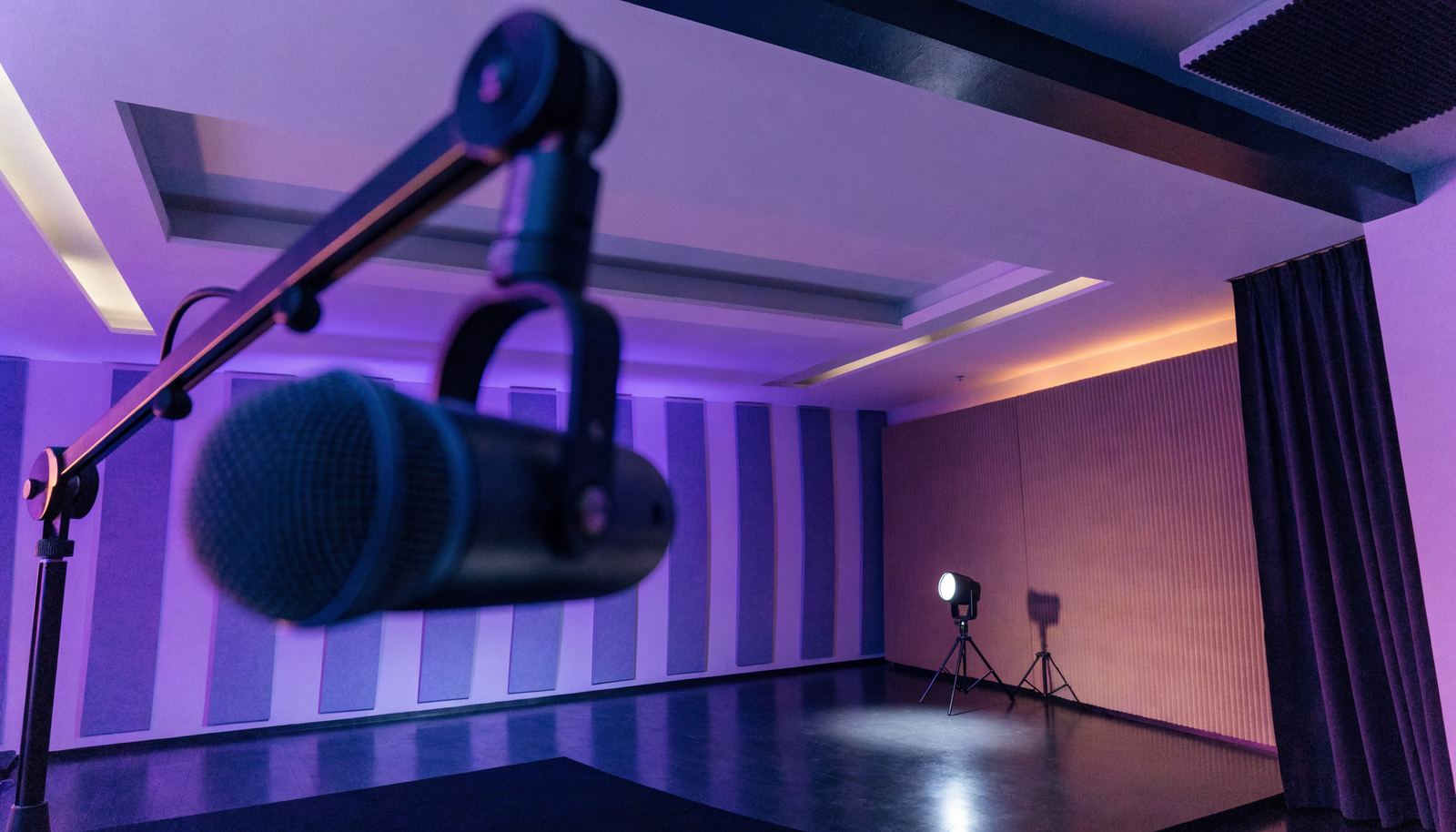 Podcast studio microphone with conference stage beyond